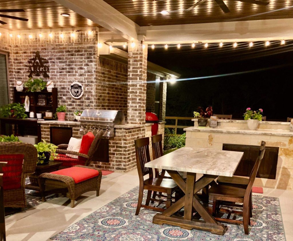 contemporary patio design with string lights and outdoor dining area in the evening