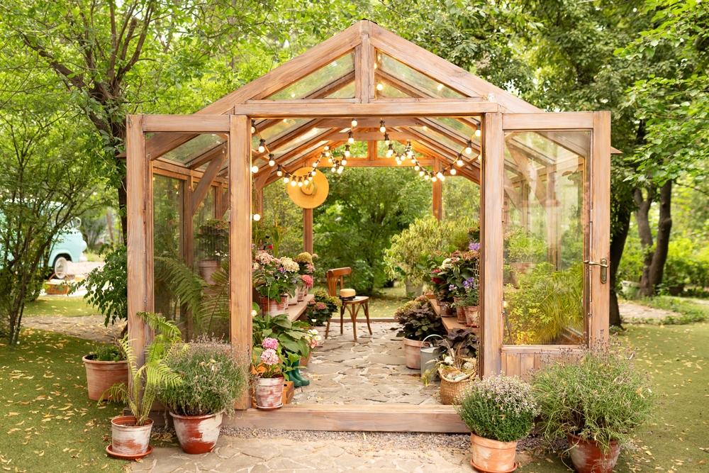 Interiorofawoodenilluminatedgreenhousewithfurnitureplantsand | h3 outdoor design & construction Backyard Garden