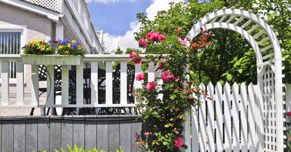 white fenced garden arbor